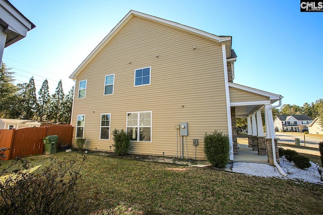 rear view of house with a lawn