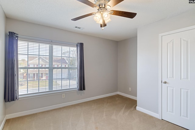 interior space featuring ceiling fan and light carpet