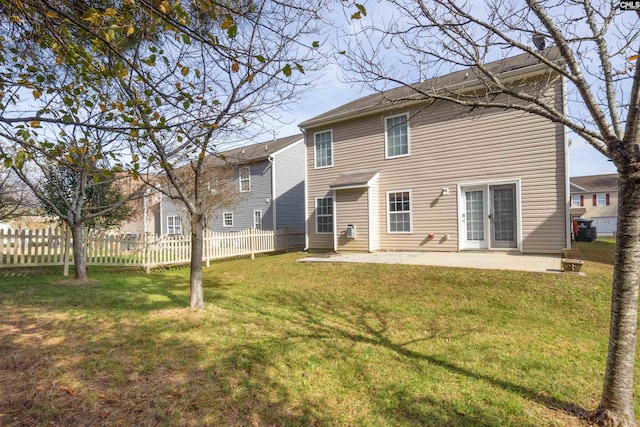 back of property featuring a lawn and a patio area