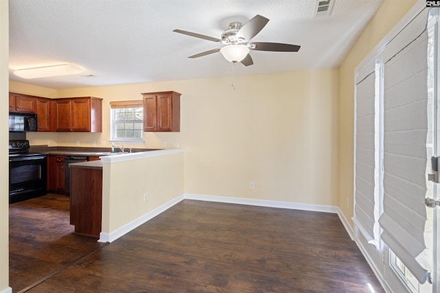 kitchen featuring kitchen peninsula, dark hardwood / wood-style flooring, ceiling fan, sink, and black appliances