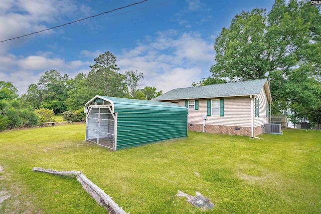 view of outdoor structure with central AC unit and a lawn