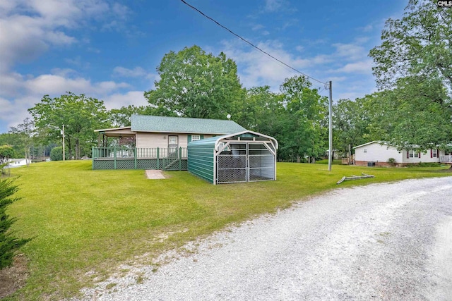 view of outdoor structure with a carport and a yard