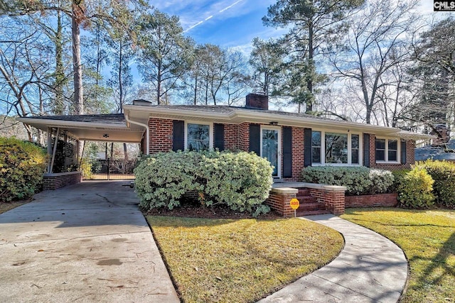 ranch-style home with a front yard and a carport