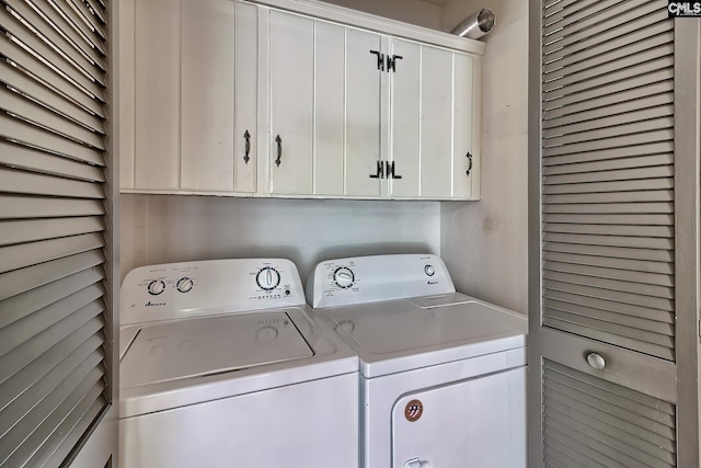 washroom with cabinets and washer and dryer