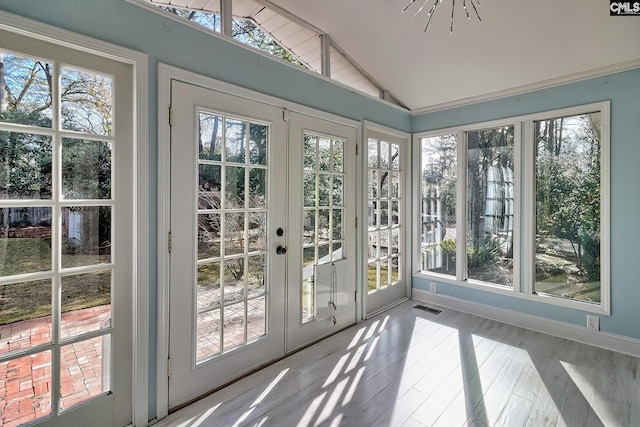 sunroom featuring french doors and vaulted ceiling