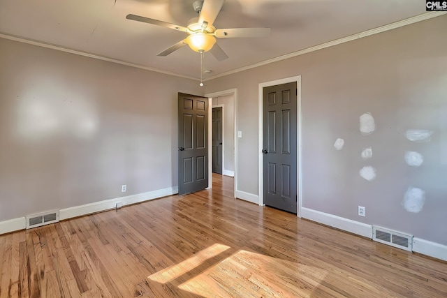 unfurnished room with crown molding, ceiling fan, and light wood-type flooring