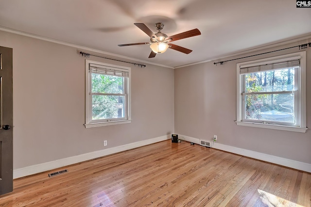 empty room with ceiling fan, light wood-type flooring, and crown molding