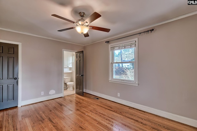 unfurnished bedroom featuring light wood-type flooring, ensuite bathroom, ceiling fan, and crown molding