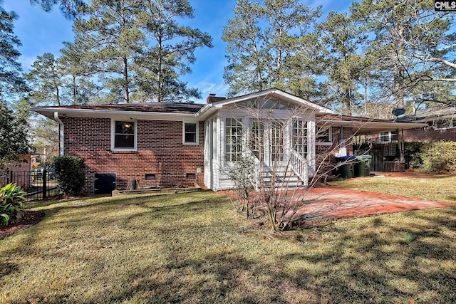 back of house featuring a yard