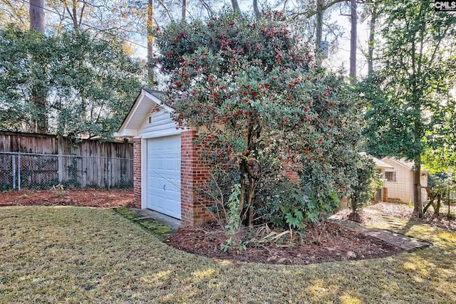 view of outbuilding featuring a lawn and a garage