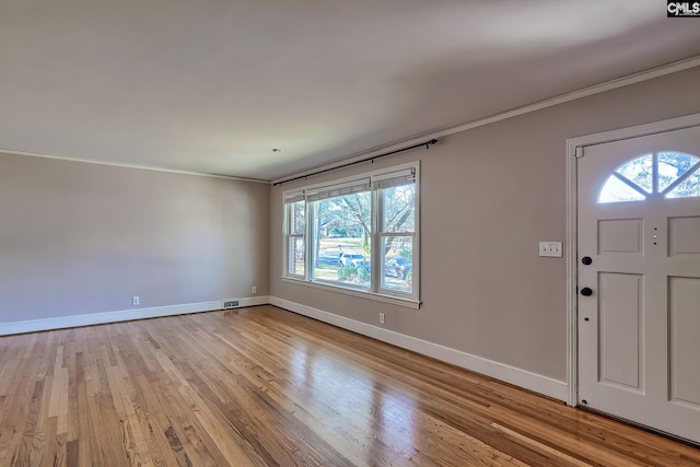 foyer featuring light hardwood / wood-style floors and crown molding