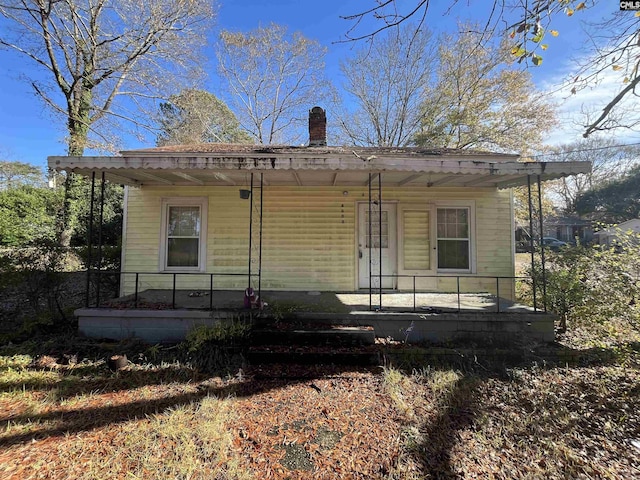 rear view of property featuring a porch