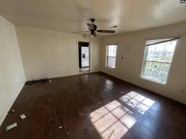 spare room featuring ceiling fan and dark hardwood / wood-style flooring