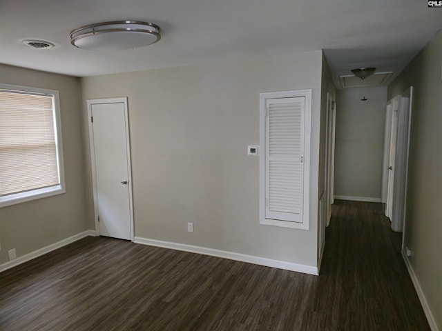 unfurnished room featuring dark wood-type flooring