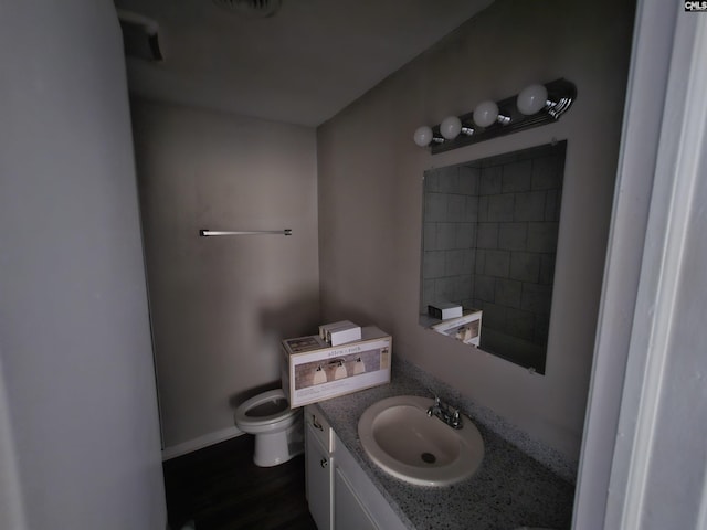 bathroom featuring vanity and toilet