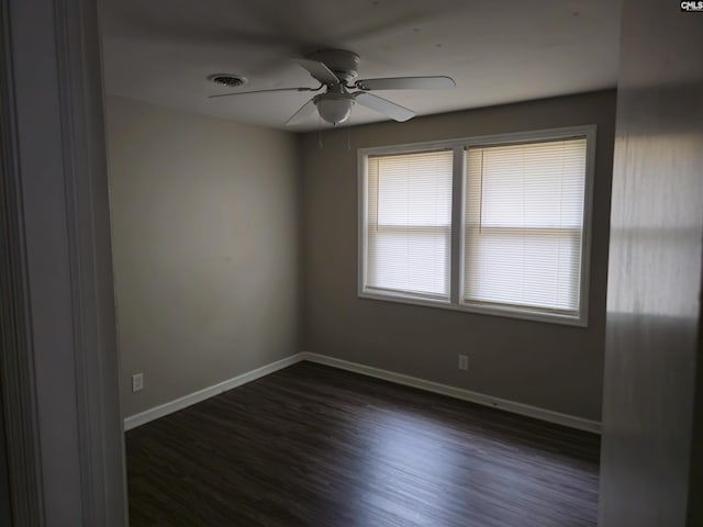 spare room with ceiling fan and dark wood-type flooring