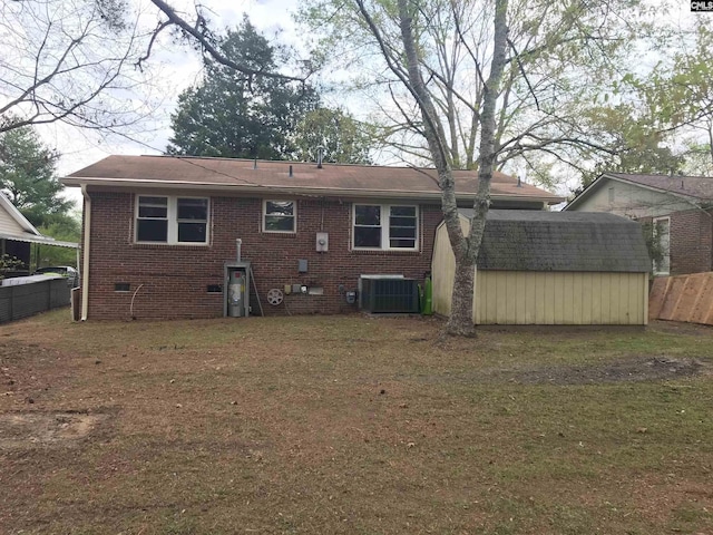 back of property with central air condition unit and a storage shed