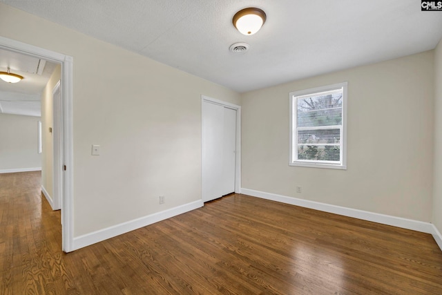 unfurnished room featuring a textured ceiling and hardwood / wood-style flooring