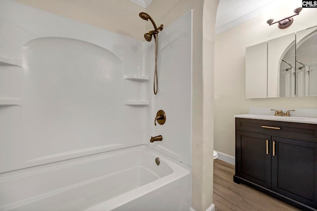 full bathroom featuring shower / bath combination, vanity, a textured ceiling, crown molding, and hardwood / wood-style floors