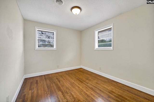 unfurnished room featuring hardwood / wood-style floors