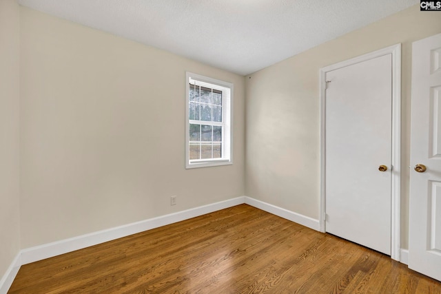 unfurnished bedroom featuring hardwood / wood-style floors