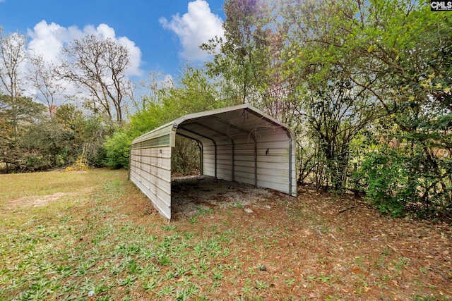 view of outbuilding featuring a lawn and a carport