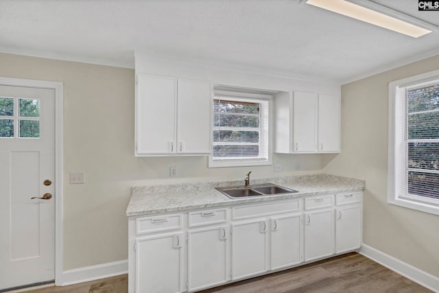 kitchen featuring sink, white cabinets, a healthy amount of sunlight, and light hardwood / wood-style floors