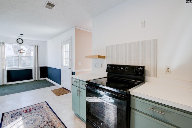 kitchen featuring a textured ceiling, decorative light fixtures, black / electric stove, and green cabinetry