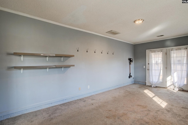 empty room with crown molding, light colored carpet, and a textured ceiling