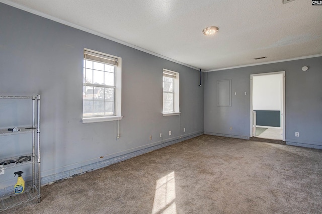 unfurnished room featuring a textured ceiling, ornamental molding, and light carpet