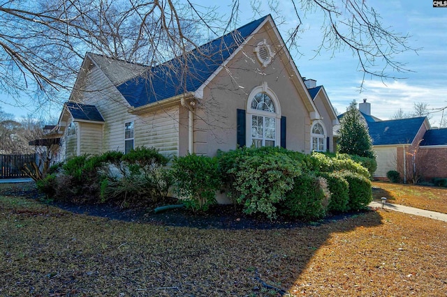 view of side of property with a lawn