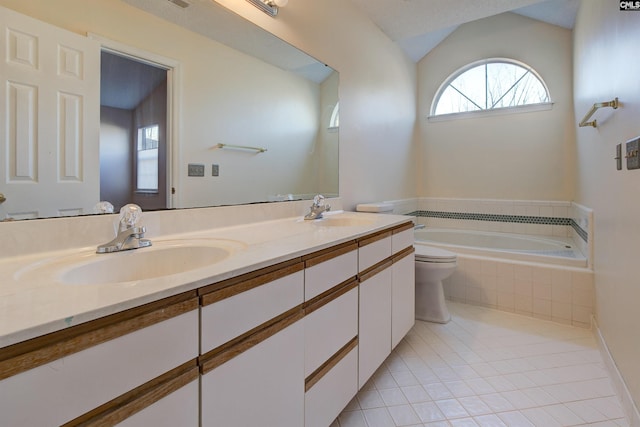 bathroom featuring tile patterned floors, tiled bath, lofted ceiling, toilet, and vanity