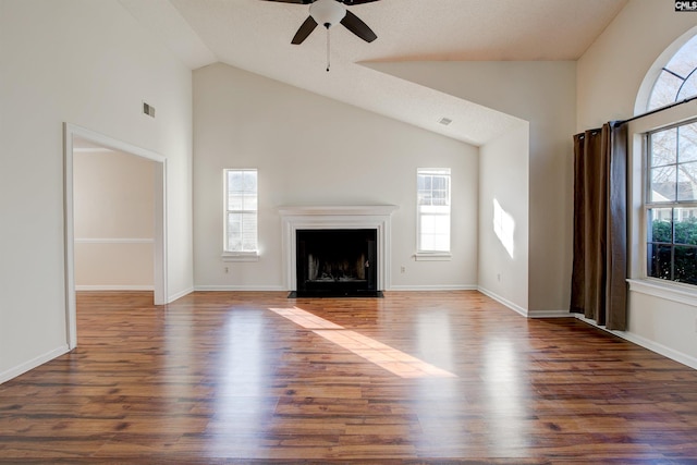 unfurnished living room featuring dark hardwood / wood-style floors, ceiling fan, and a healthy amount of sunlight