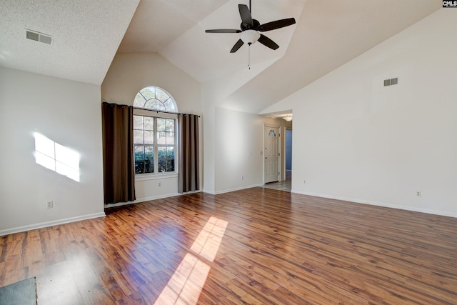 spare room with hardwood / wood-style flooring, vaulted ceiling, and ceiling fan