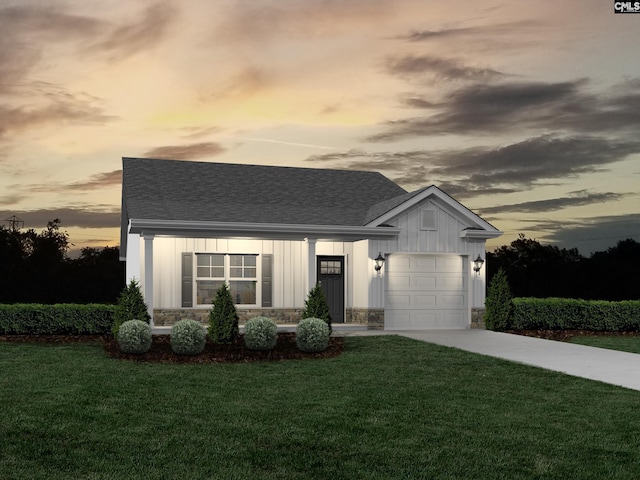 view of front of property featuring a garage and a yard