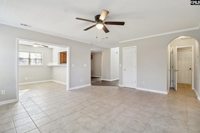 unfurnished room with crown molding, ceiling fan, and light tile patterned flooring