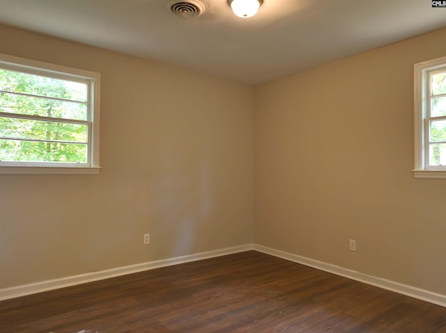 spare room featuring dark hardwood / wood-style floors