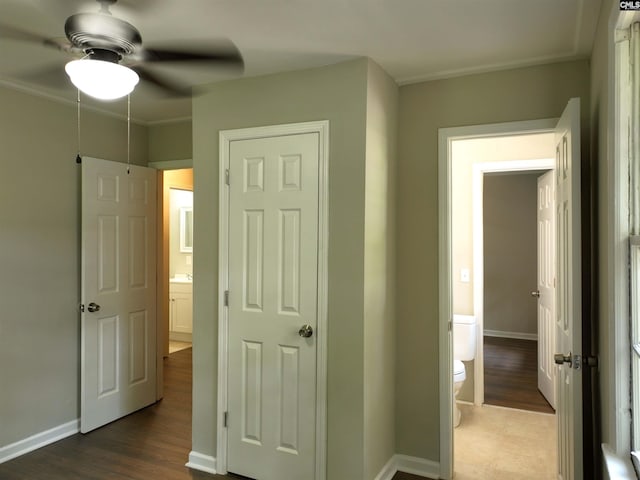 unfurnished bedroom featuring connected bathroom, ceiling fan, and dark hardwood / wood-style flooring