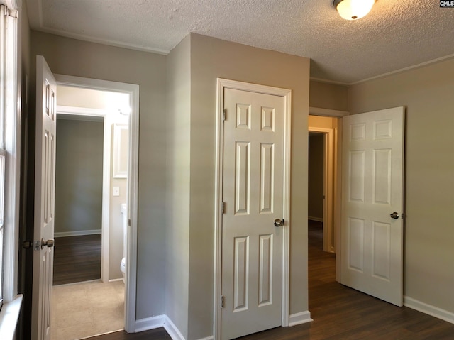 hall featuring dark hardwood / wood-style floors and a textured ceiling