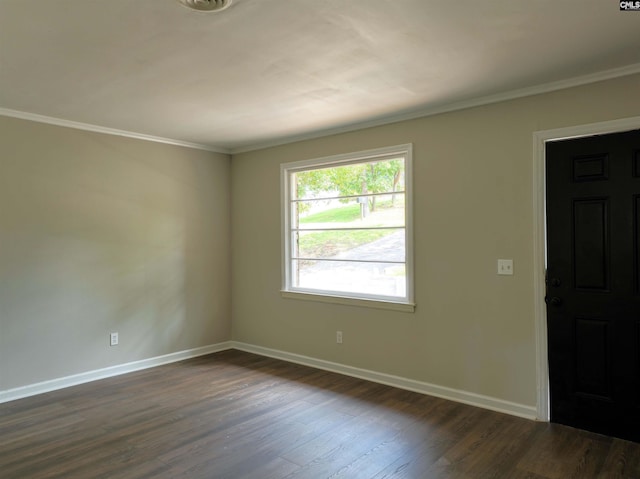 empty room featuring dark hardwood / wood-style floors and ornamental molding