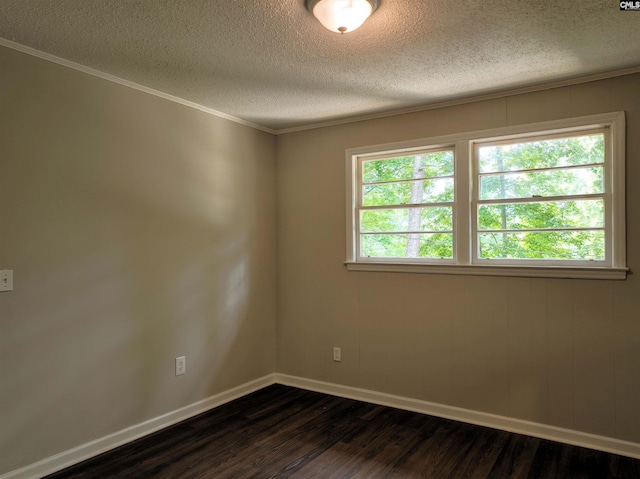 empty room featuring dark hardwood / wood-style floors and a textured ceiling