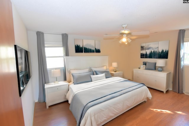 bedroom with hardwood / wood-style flooring and ceiling fan