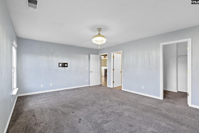 unfurnished room with dark carpet