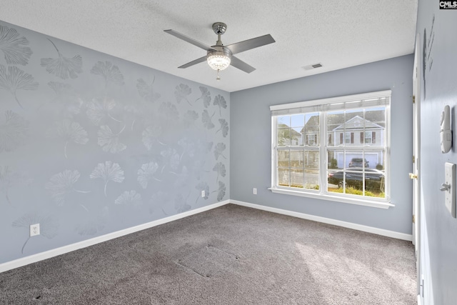 carpeted empty room with a textured ceiling and ceiling fan