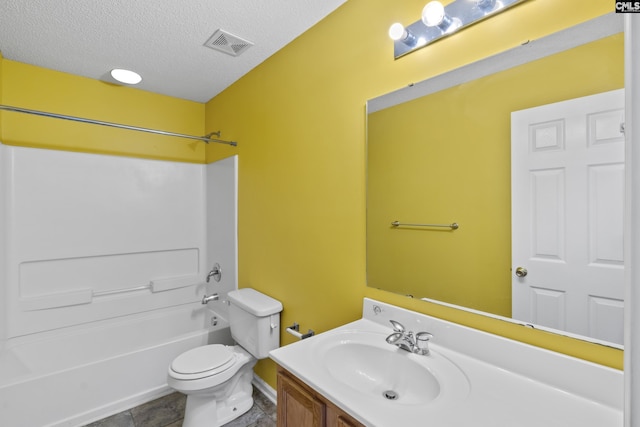 full bathroom with tile patterned floors, a textured ceiling, toilet, shower / washtub combination, and vanity