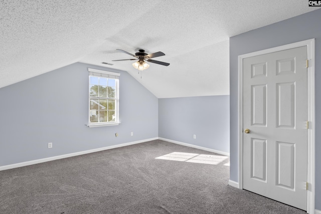 additional living space with a textured ceiling, carpet floors, ceiling fan, and lofted ceiling