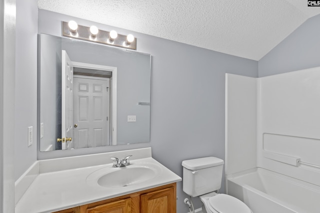 full bathroom featuring shower / bath combination, vaulted ceiling, a textured ceiling, toilet, and vanity