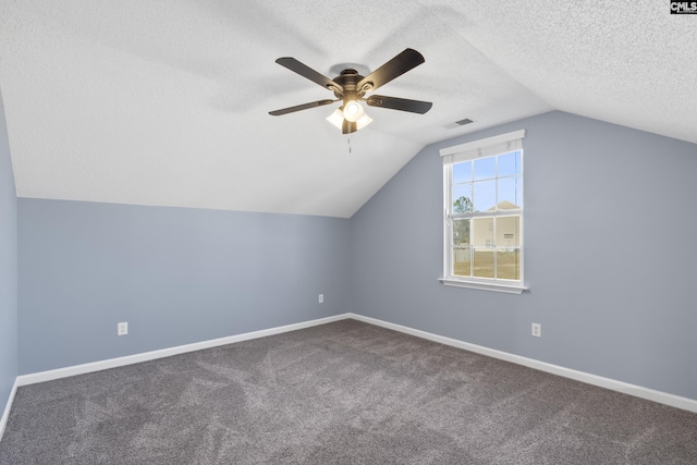 bonus room with carpet, ceiling fan, a textured ceiling, and vaulted ceiling