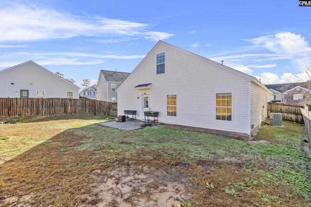 back of house with a yard, a patio area, and central air condition unit