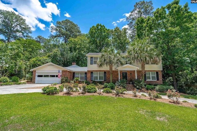 view of front of house with a front lawn and a garage